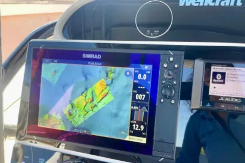 Slide: The Image of Dashboard of a 2006 Wellcraft 32 CCF boat with Simrad navigation display. - 37
