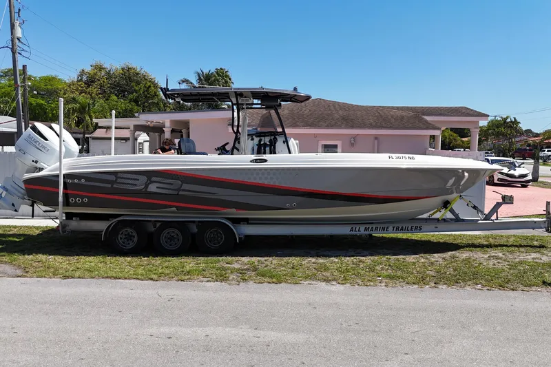 Slide: The Image of 2006 Wellcraft 32 CCF boat on trailer, parked outdoors, with modern design and graphics. - 4
