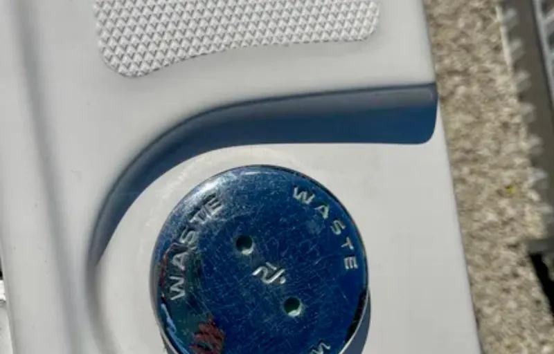 Slide: The Image of Waste cap on 2006 Wellcraft 32 CCF boat, featuring textured surface and blue detailing. - 41