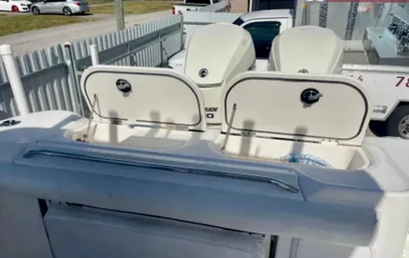 Slide: The Image of 2006 Wellcraft 32 CCF boat with open storage compartments and dual outboard engines. - 43