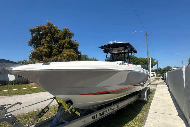 Slide: The Image of 2006 Wellcraft 32 CCF boat on trailer, parked outdoors under clear blue sky. - 5