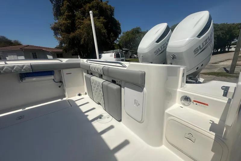 Slide: The Image of 2006 Wellcraft 32 CCF boat deck with Suzuki outboard engines, featuring storage compartments. - 53