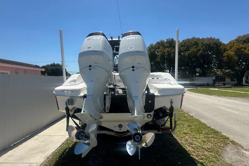 Slide: The Image of 2006 Wellcraft 32 CCF boat with dual outboard engines, parked outdoors. - 55