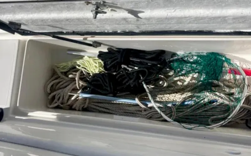 Slide: The Image of Storage compartment with ropes and nets on a 2006 Wellcraft 32 CCF boat. - 57