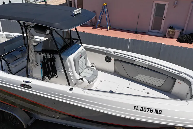 Slide: The Image of 2006 Wellcraft 32 CCF boat with sleek design, parked on a trailer. - 8