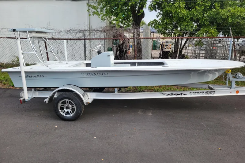 The Image of 2026 Mitzi Skiffs 17 Tournament boat on trailer, parked outdoors. - 1