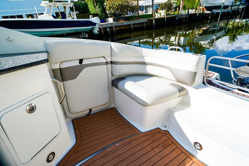 Slide: The Image of 2017 Hurricane SunDeck 2690 OB boat interior with cushioned seating and wooden flooring. - 10