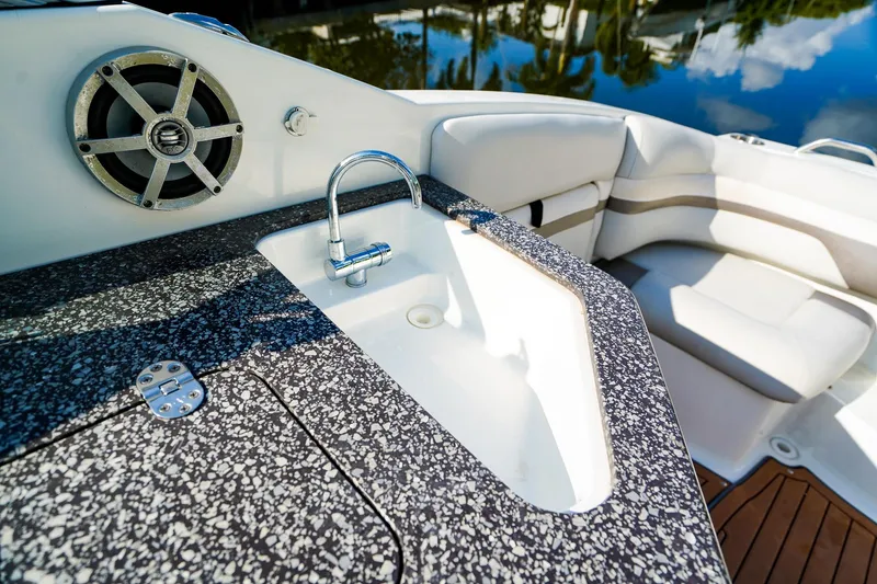 Slide: The Image of 2017 Hurricane SunDeck 2690 OB boat interior with sink and speaker. - 12