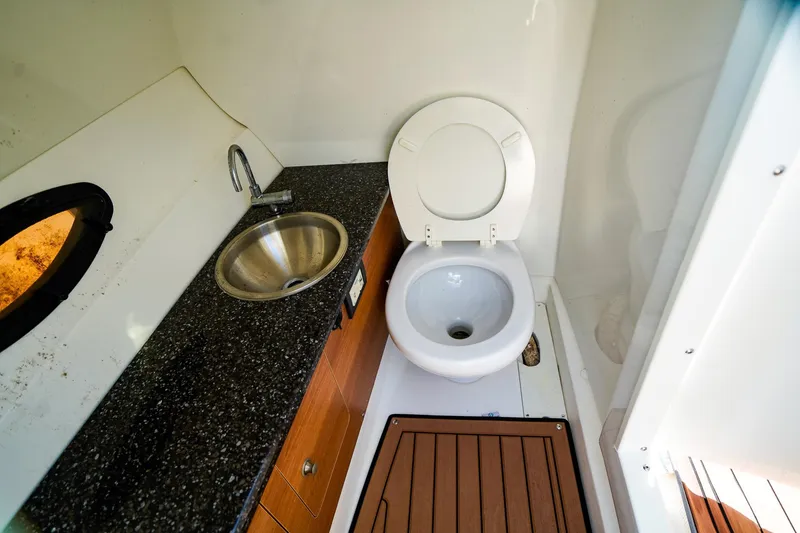 Slide: The Image of 2017 Hurricane SunDeck 2690 OB boat bathroom with sink and toilet. - 15
