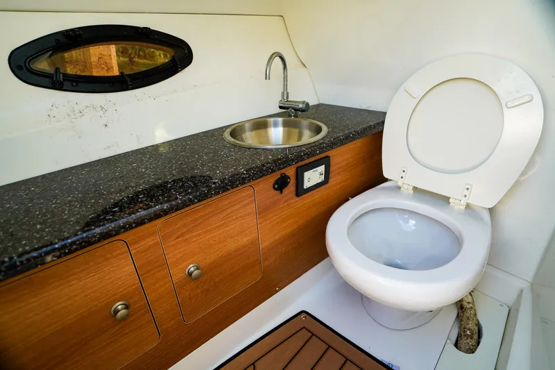 Slide: The Image of 2017 Hurricane SunDeck 2690 OB boat bathroom with sink and toilet. - 16
