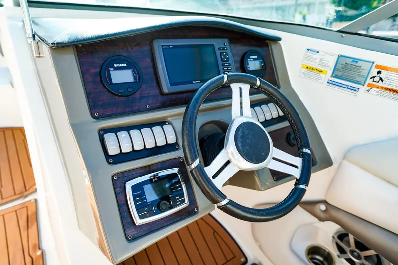 Slide: The Image of 2017 Hurricane SunDeck 2690 OB boat dashboard with steering wheel and control panel. - 18