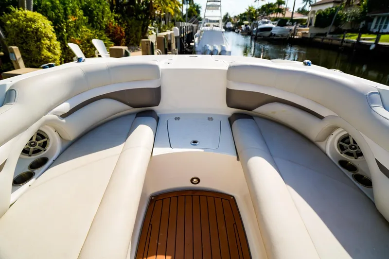 Slide: The Image of 2017 Hurricane SunDeck 2690 OB boat interior with cushioned seating and wood flooring. - 19