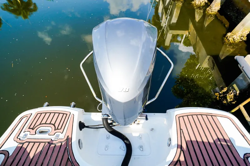 Slide: The Image of 2017 Hurricane SunDeck 2690 OB boat with outboard motor on calm water. - 5