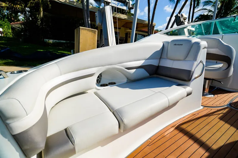 Slide: The Image of Luxurious seating on 2017 Hurricane SunDeck 2690 OB boat with sleek design and wood flooring. - 8