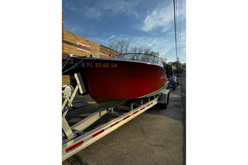 The Image of 2019 Hacker-Craft 23 Runabout on trailer, parked on street under clear sky. - 1