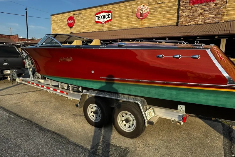 Slide: The Image of 2019 Hacker-Craft 23 Runabout boat on trailer, parked near Texaco sign. - 10