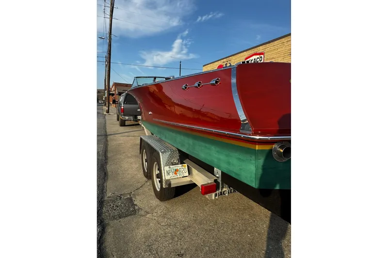 Slide: The Image of 2019 Hacker-Craft 23 Runabout boat on trailer, vibrant red and green finish. - 15