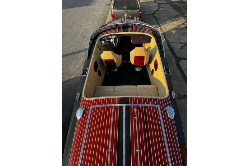Slide: The Image of 2019 Hacker-Craft 23 Runabout with polished wood finish and beige interior, viewed from above. - 21
