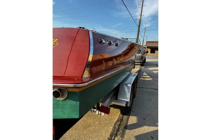 Slide: The Image of 2019 Hacker-Craft 23 Runabout boat on trailer, showcasing polished wood finish. - 28