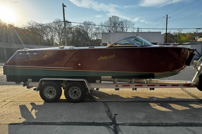 Slide: The Image of 2019 Hacker-Craft 23 Runabout boat on a trailer, parked outdoors. - 3