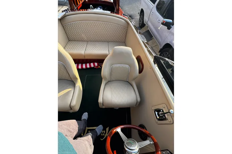 Slide: The Image of 2019 Hacker-Craft 23 Runabout interior with beige leather seats and wooden steering wheel. - 5