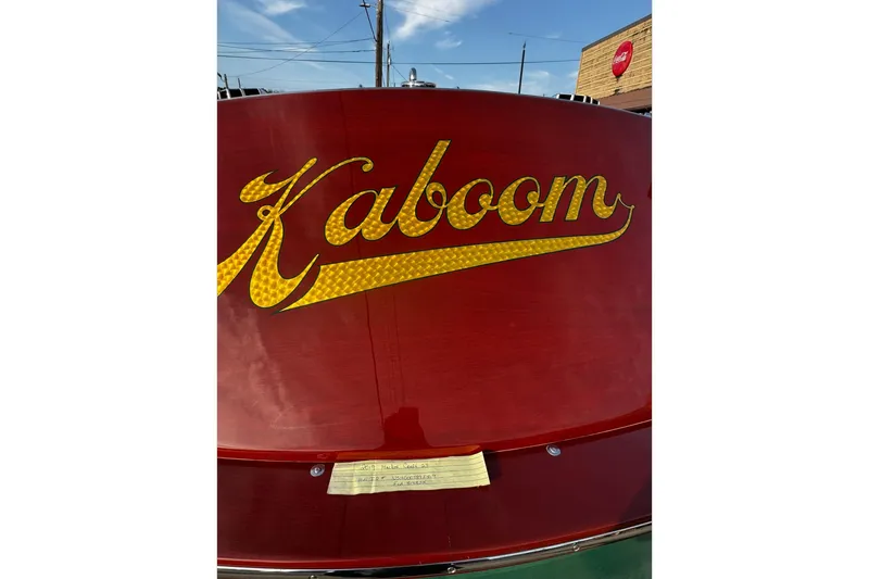 Slide: The Image of 2019 Hacker-Craft 23 RUNABOUT with "Kaboom" in gold lettering on red wood finish. - 8