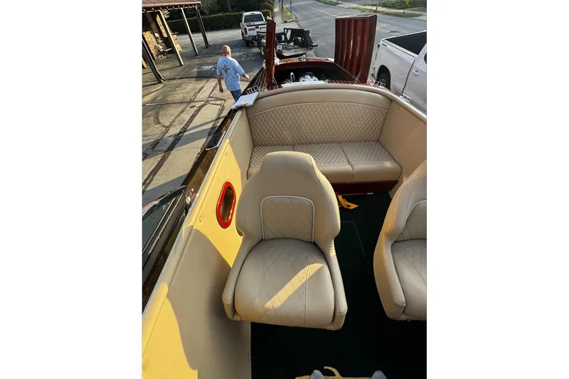 Slide: The Image of 2019 Hacker-Craft 23 Runabout interior with beige leather seats and wood accents. - 9