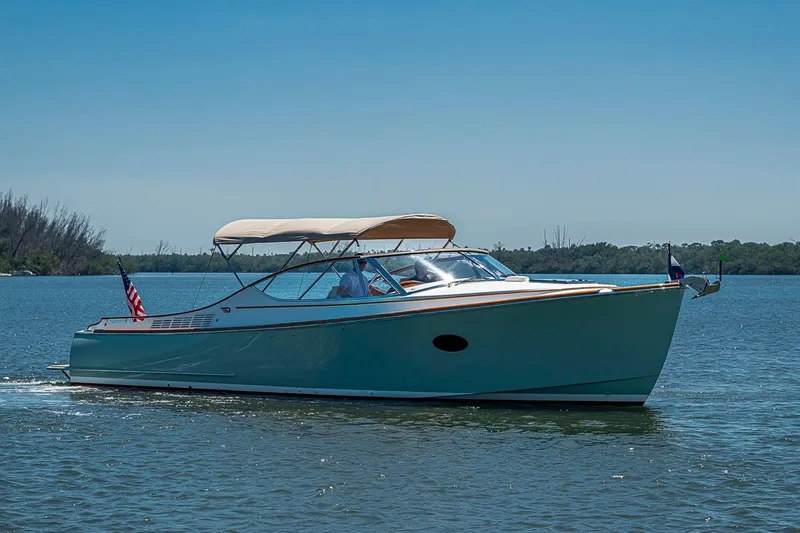 Slide: The Image of 2017 Hinckley Talaria 34R cruising on a sunny day, featuring elegant design and American flag. - 1