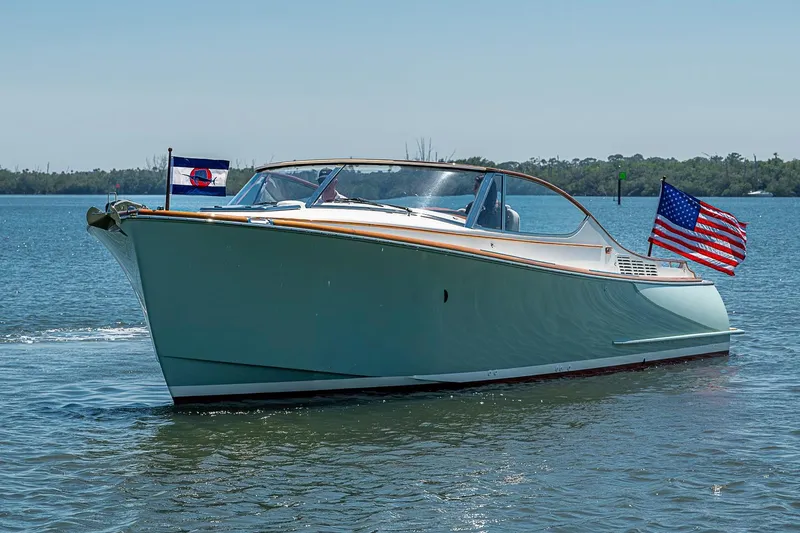 Slide: The Image of 2017 Hinckley Talaria 34R cruising on a serene lake with two passengers. - 2