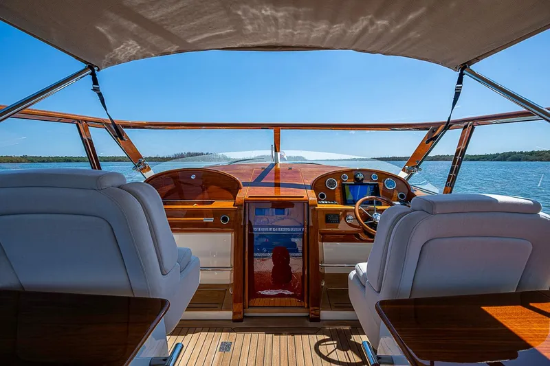 Slide: The Image of Luxurious interior of 2017 Hinckley Talaria 34R yacht with wooden paneling and blue seating. - 21