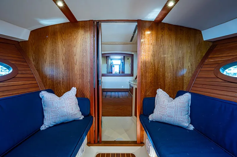 Slide: The Image of Interior of 2017 Hinckley Talaria 34R yacht with blue seating and wooden cabinetry. - 22