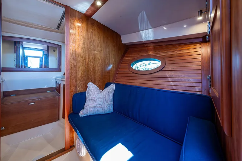 Slide: The Image of Interior of 2017 Hinckley Talaria 34R yacht with wooden cabinetry and mirror. - 24