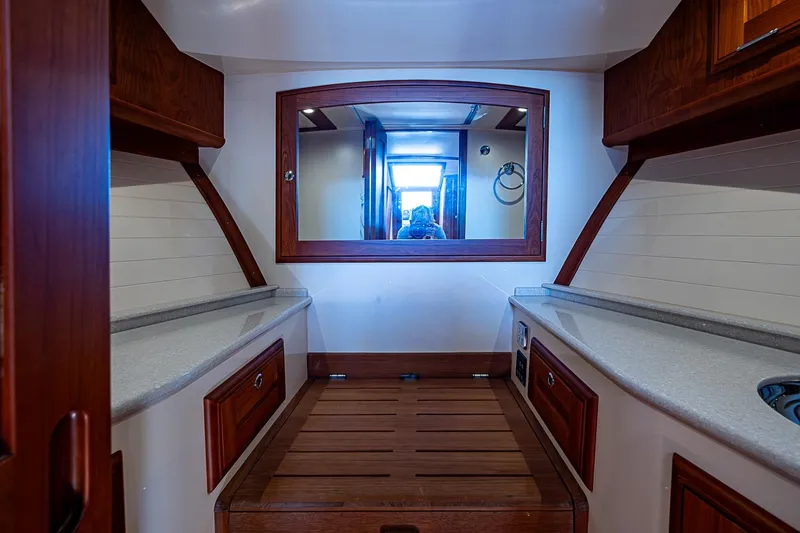 Slide: The Image of Luxurious 2017 Hinckley Talaria 34R yacht bathroom with elegant wood cabinetry and modern fixtures. - 25