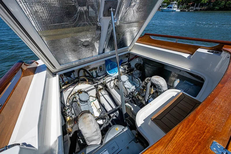 Slide: The Image of Open storage compartment on 2017 Hinckley Talaria 34R yacht with cleaning supplies inside. - 29