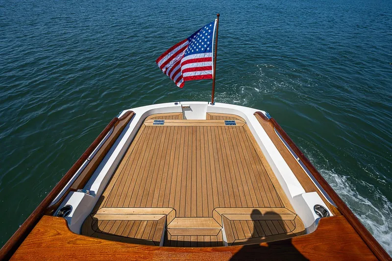 Slide: The Image of 2017 Hinckley Talaria 34R yacht with American flag on open water. - 6