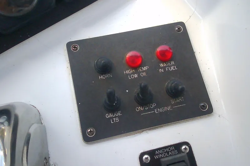 Slide: The Image of Control panel of a 1999 Sabre 34 boat with switches and warning lights. - 20