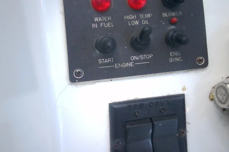 Slide: The Image of Control panel of a 1999 Sabre 34 boat with switches and indicators. - 22