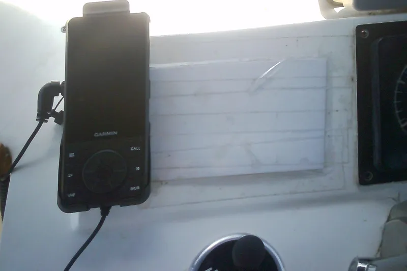 Slide: The Image of Garmin device mounted on a 1999 Sabre 34 boat dashboard. - 29