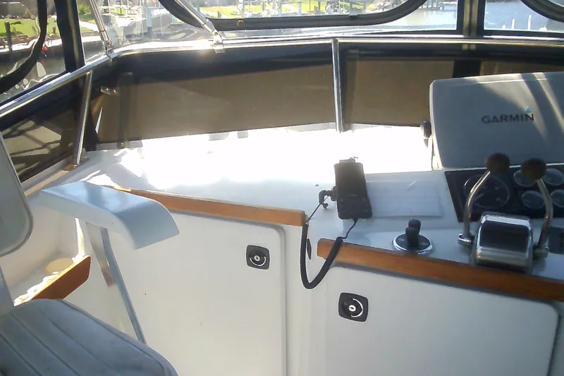 Slide: The Image of Interior view of a 1999 Sabre 34 boat cockpit with Garmin navigation system. - 33