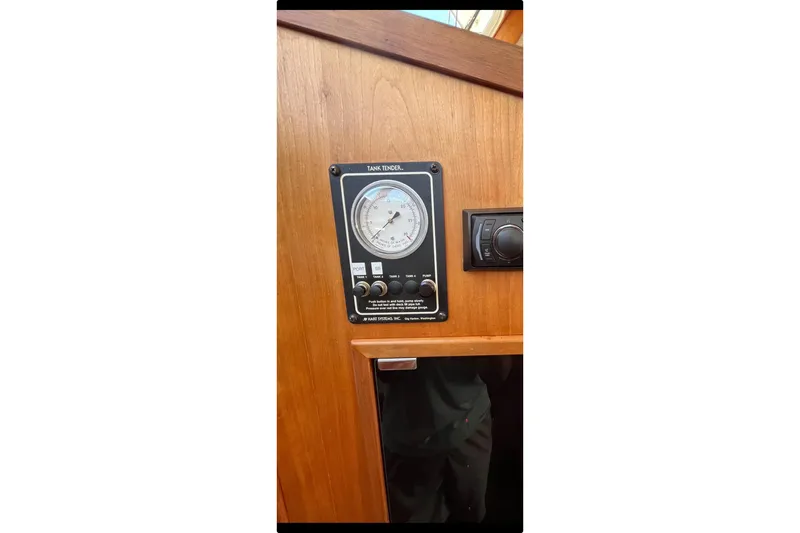Slide: The Image of Tank tender gauge on 1999 Sabre 34 boat, mounted on wooden panel. - 41