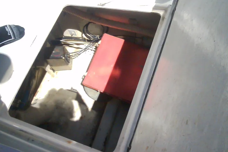 Slide: The Image of Open compartment of a 1999 Sabre 34 boat showing wiring and a red box. - 43