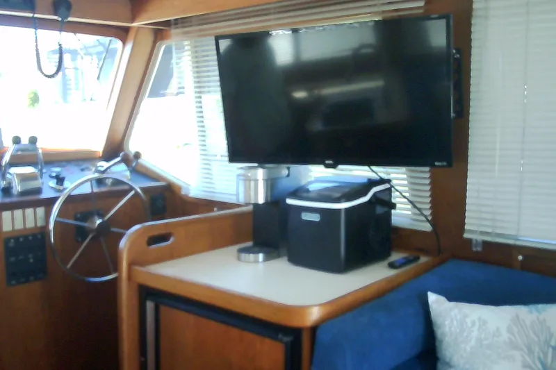 Slide: The Image of Blue sofa with starfish-themed pillows on a 1999 Sabre 34 boat interior. - 49