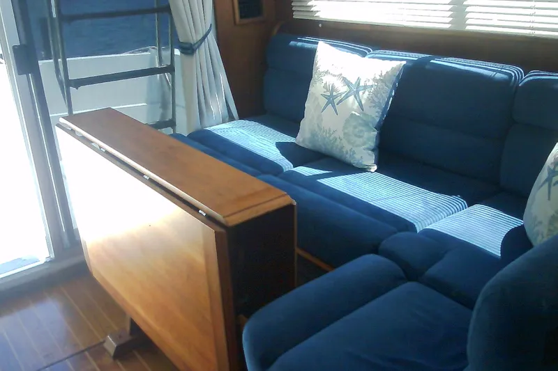 Slide: The Image of Cozy cabin interior of 1999 Sabre 34 yacht with wooden paneling and patterned bedding. - 55