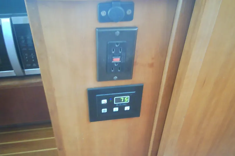 Slide: The Image of Reflection on a Sabre 34 boat's control panel, showing various settings and buttons. - 66
