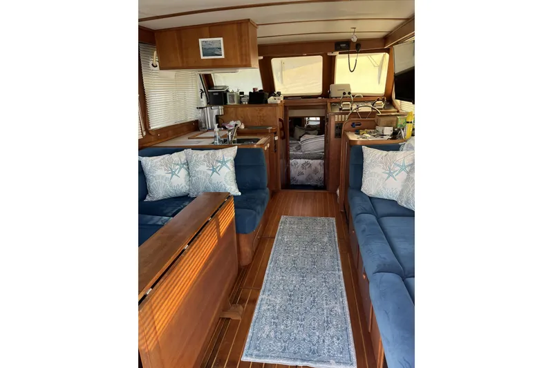 Slide: The Image of 1999 Sabreline Swift Trawler on trailer, blue hull, outdoor setting. - 86