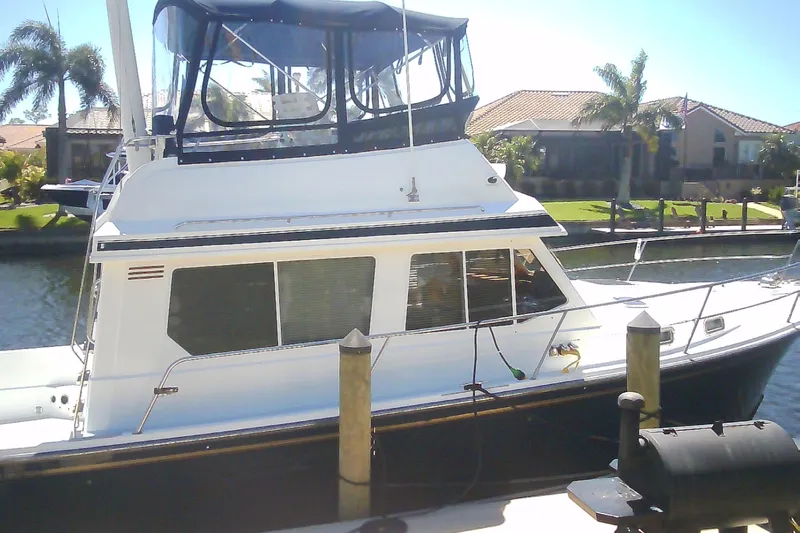 Slide: The Image of 1999 Sabre 34 boat docked in sunny marina with palm trees. - 11