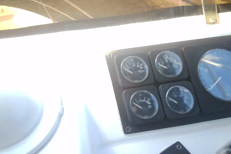 Slide: The Image of Dashboard gauges on a 1999 Sabre 34 boat, displaying various instrument readings. - 25