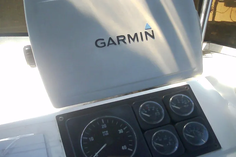 Slide: The Image of Garmin navigation system and gauges on 1999 Sabre 34 boat dashboard. - 27