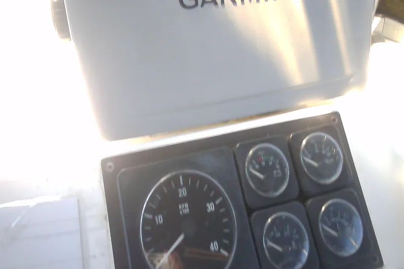 Slide: The Image of Dashboard of a 1999 Sabre 34 boat with Garmin navigation equipment. - 28