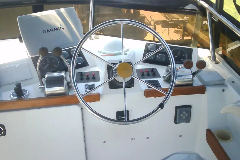 Slide: The Image of Helm of 1999 Sabre 34 sailboat with Garmin navigation system and steering wheel. - 34